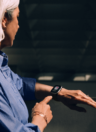 A person reads a Hypertension alert on her Apple Watch Series 11