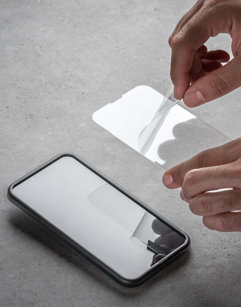 Person putting screen protector on iPhone
