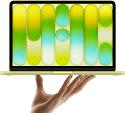 MacBook Neo in citrus colour, balanced on fingertips of open hand, screen displaying colourful abstract pattern