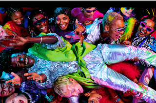 Colourful screen on a MacBook Pro of a person crowdsurfing at a party, showcasing the vibrant Liquid Retina XDR display