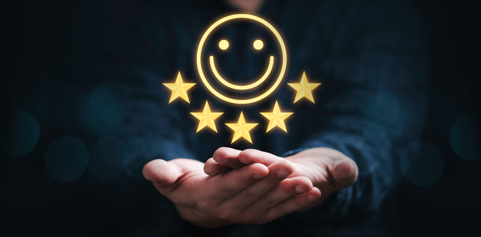 Smiley face with 5 stars below being held up by two cupped hands